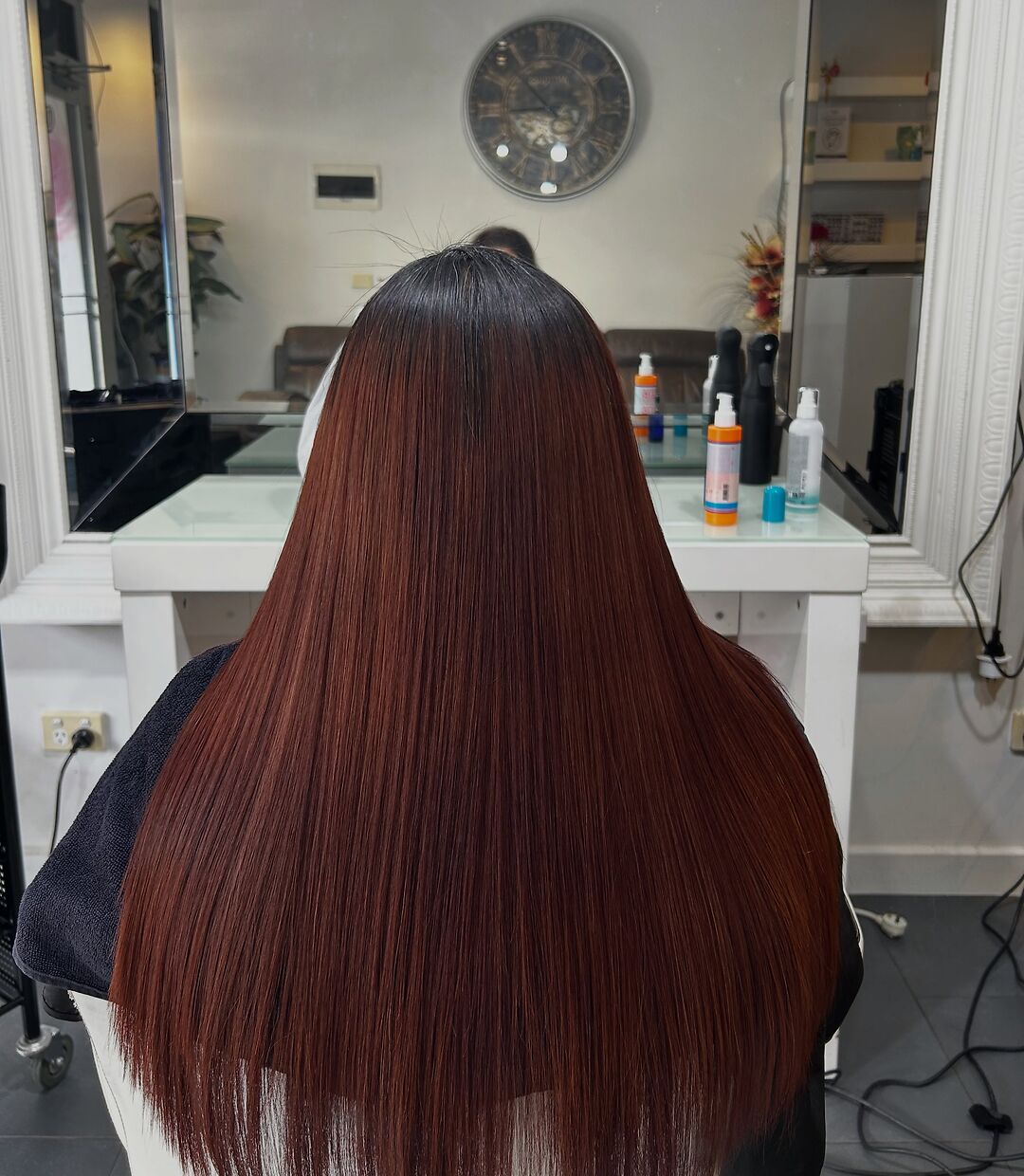 Sleek burgundy hair after Brazilian keratin at Akila Oakleigh