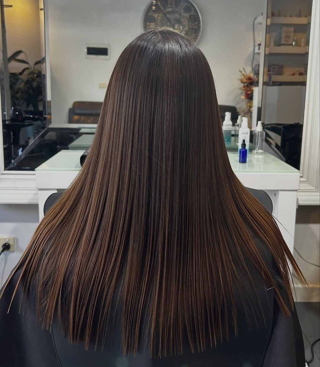 Sleek glossy long brown hair after Cacau Brasil Nanoplastia at Akila Oakleigh
