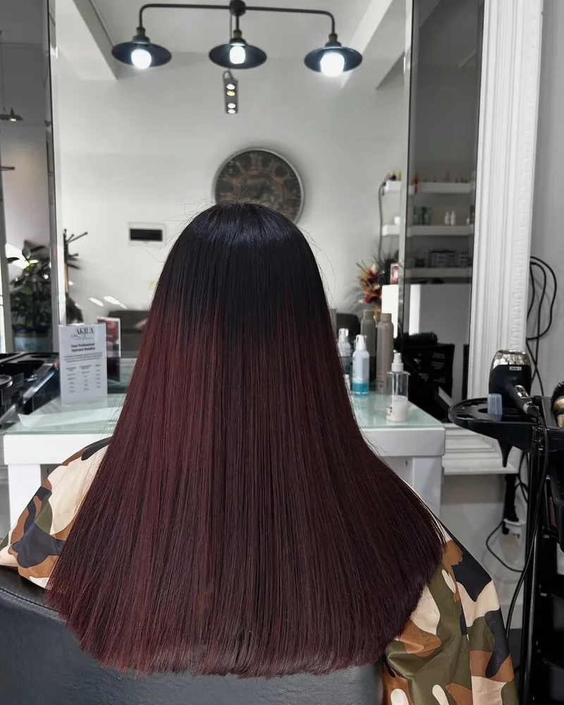 Deep mahogany colour result with a glass-smooth finish at Akila Hair and Beauty in Oakleigh