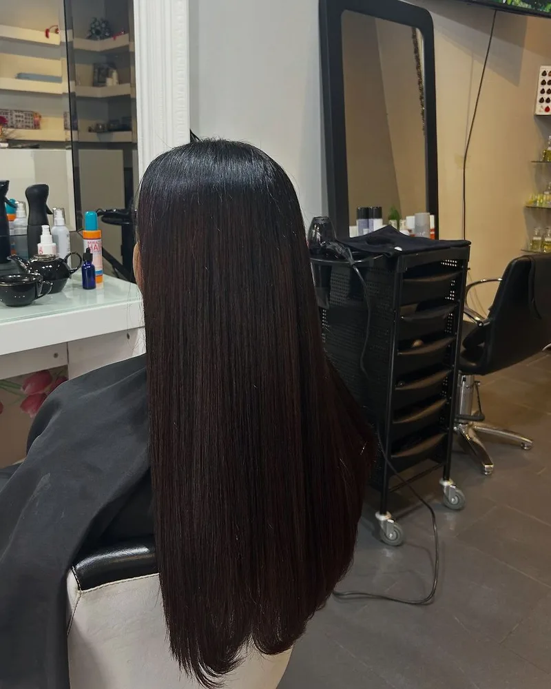 Glossy brunette hair colour result at Akila in Oakleigh