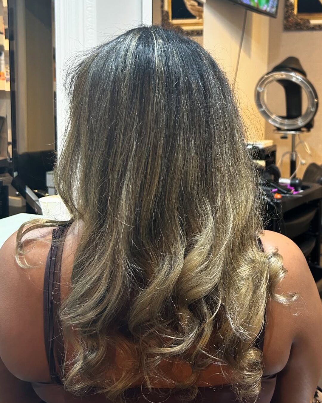 Ash blonde balayage through long waves at Akila in Oakleigh