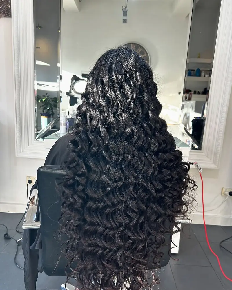 Long glossy dark curls styling result at Akila Oakleigh