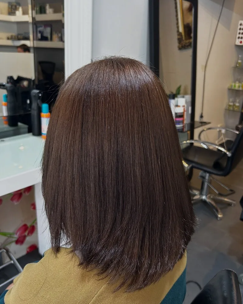 Shoulder-length lob cut with a soft blunt line and glossy finish at Akila Hair and Beauty, Oakleigh
